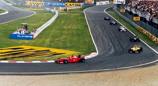 red F1 Ferrari in the lead at hairpin corner at the Montreal Gran Prix June 7, 1998